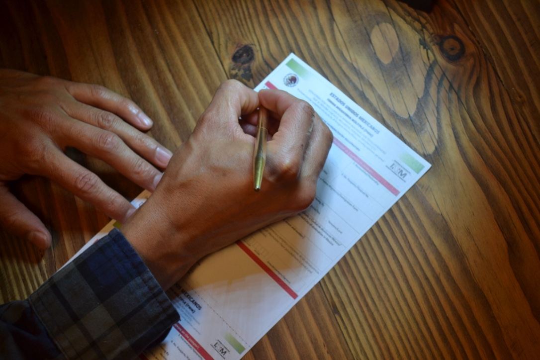 Advisor guiding a client while filling out an immigration form